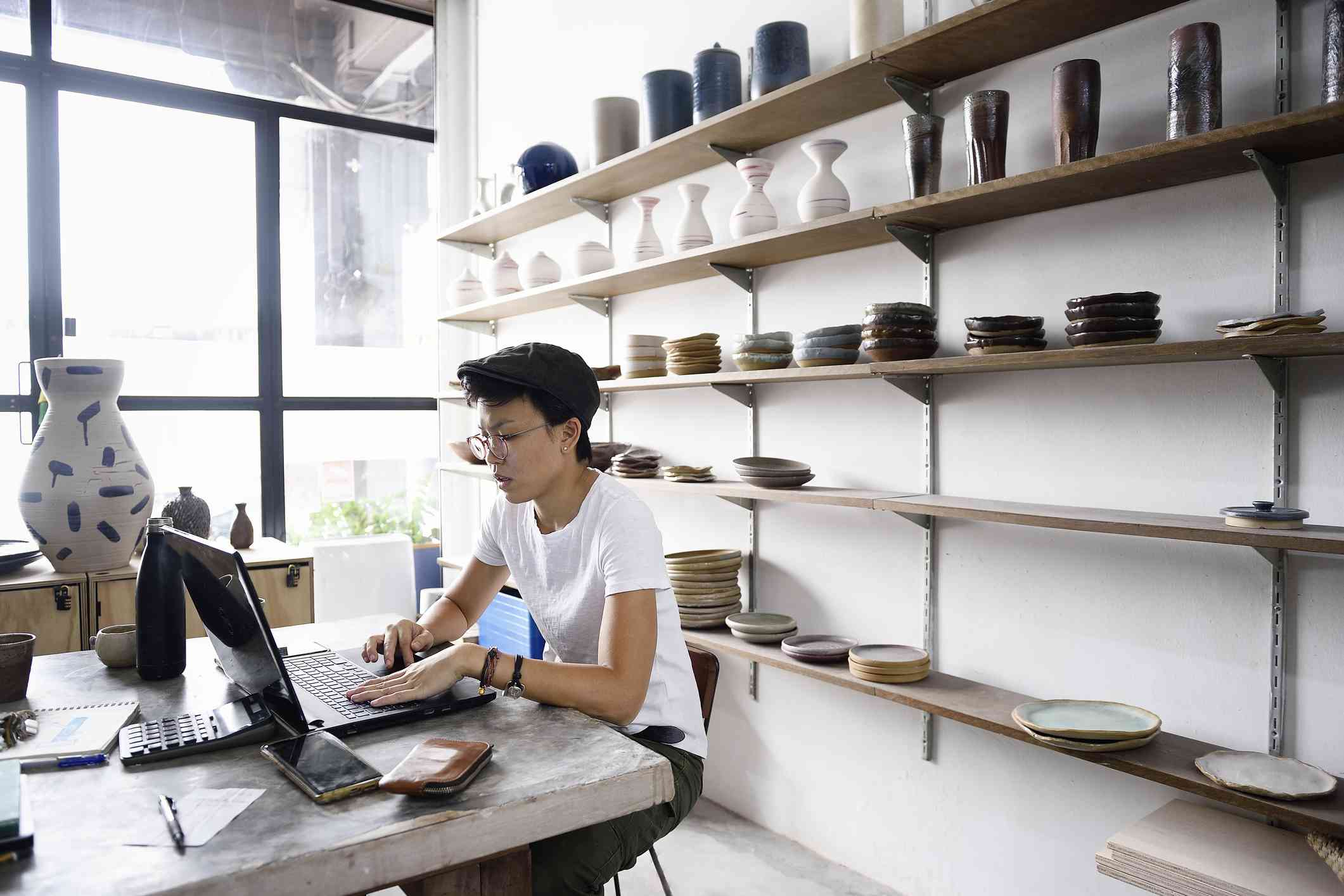 An entrepreneur working from her laptop in her store.