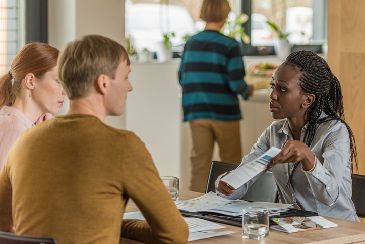 Woman helping couple with finances