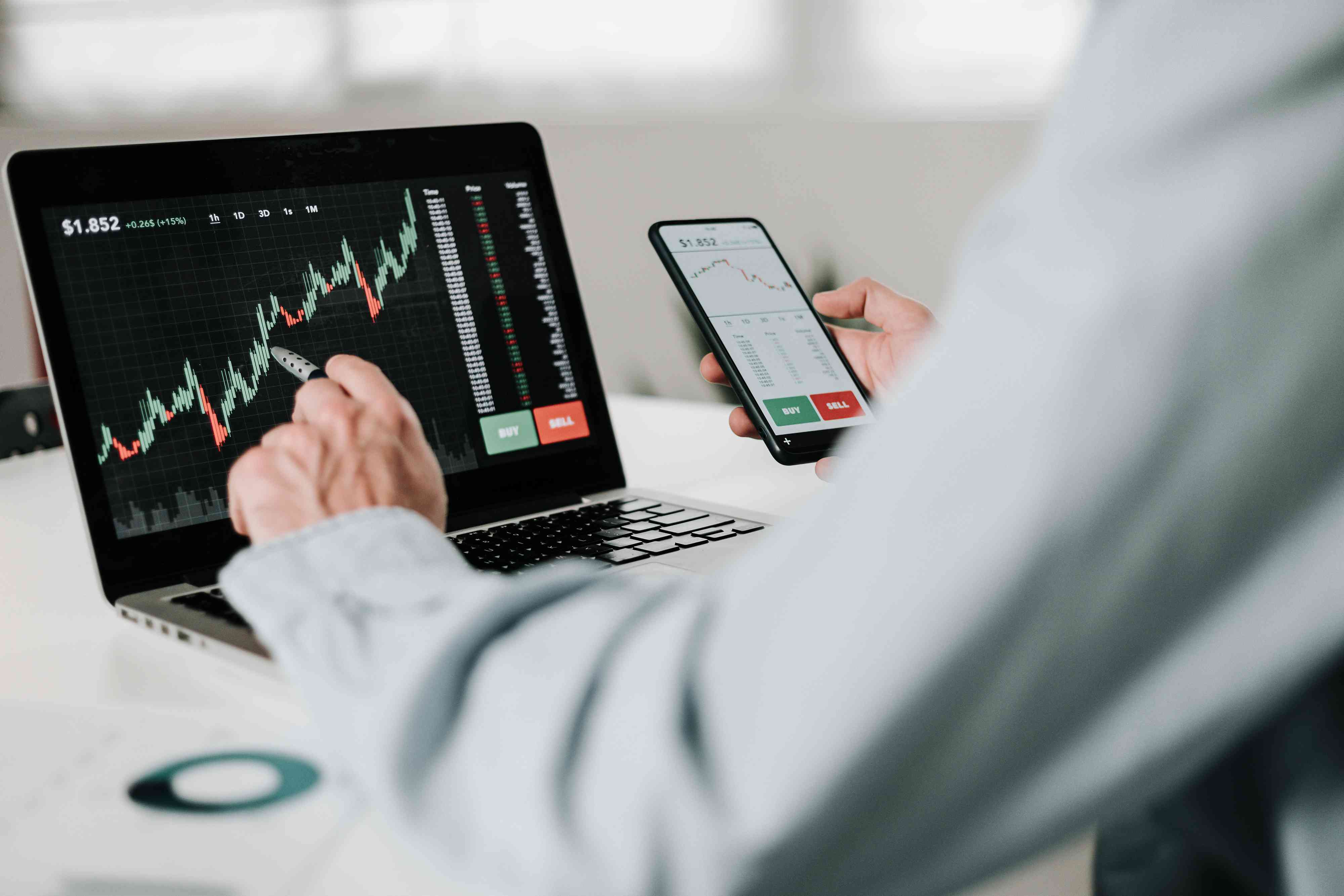 Young adult man using smart phone to monitor market and stock trading in AI